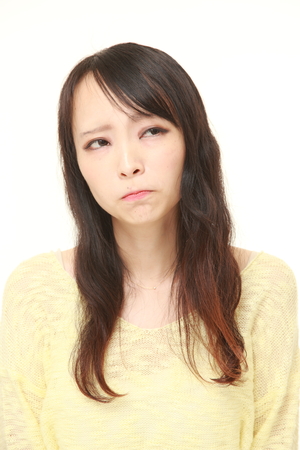 51880714 - young japanese woman worries about something