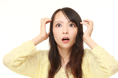 62835430 - young japanese woman shocked